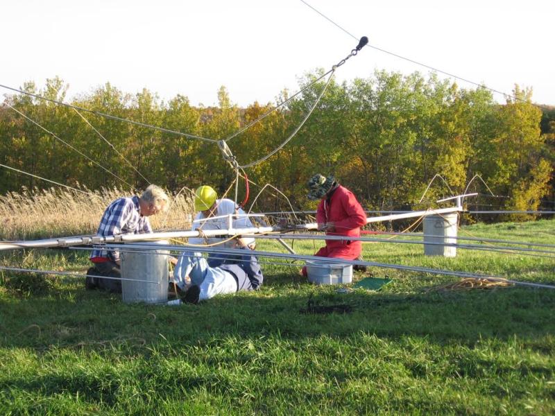 (laying down) KA9FOX, (L-R) Bill KE9XQ, Eric KB9TKF and Paul WØAIH preparing C4XL for installation. (pic courtesy WA9