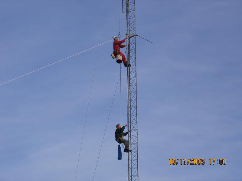 Paul WØAIH (top) and Chris KC9DGP (bottom) ride up the tower on the Gin Pole rope. (pic courtesy WA9HCZ)