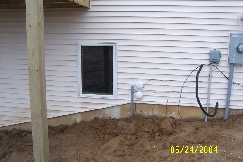 The two white circles are 4 inch PVC caps, covering 4 inch PVC pipes that will be the cable entry path into the shack.
