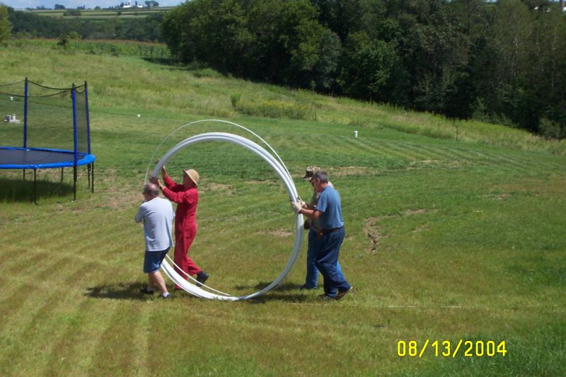 L-R: K0MN, W0AIH, N9OY and KB9YXV help roll out the Polygon Fiberglass Guy Rod.