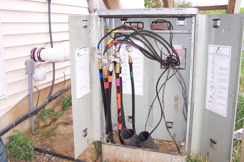 This is the box by the house, with feedlines and conduits from tower coming in. Poly Phaser lightning protectors are installed b