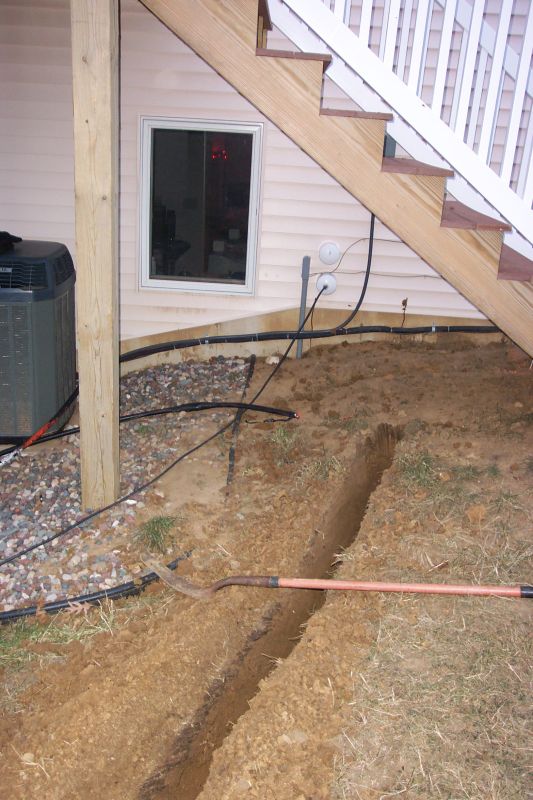 The house end of the trench.  Radio room is behind window to the left.  Two 4 inch PVC pipes going into the house can be seen to