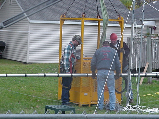 Fastening the 80M antenna to cage to raise it up.