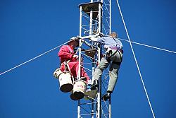 (L-R) Paul WØAIH and Chris KC9DGP working on tower.  Note guy wires are Polygon Fiberglass Rod.  Also note rope going