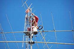 Paul WØAIH mounting 2 meter beam at the top of the mast.  Approximate height is 108 feet.