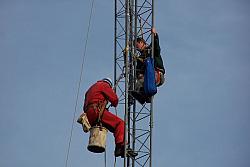 Paul WØAIH and Chris KC9DGP work on removing the Gin Pole made from Rohn 25.
