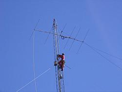 Paul WØAIH climbs tower after 6m beam was pulled to the top. (Photo by WA9HCZ)