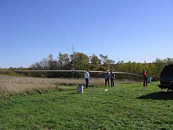 Eric KB9TKF, Bill KE9XQ, Scott KA9FOX and Paul WØAIH prepare to raise F12 80m dipole for testing.  Note temporary mast installed