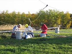 (laying down) KA9FOX, (L-R) Bill KE9XQ, Eric KB9TKF and Paul WØAIH preparing C4XL for installation. (pic courtesy WA9