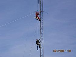 Paul WØAIH (top) and Chris KC9DGP (bottom) ride up the tower on the Gin Pole rope. (pic courtesy WA9HCZ)
