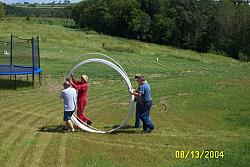 L-R: K0MN, W0AIH, N9OY and KB9YXV help roll out the Polygon Fiberglass Guy Rod.