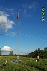 W0AIH on the tower, getting ready to raise the gin pole.