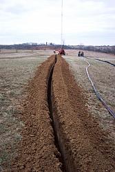 Trench was about 3 feet deep.  Trenching was done on December 16th, 2004, perhaps a day or two before the ground froze.