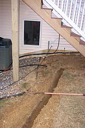 The house end of the trench.  Radio room is behind window to the left.  Two 4 inch PVC pipes going into the house can be seen to