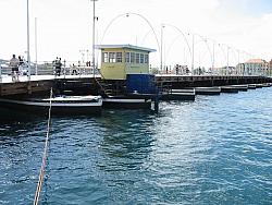Queen Emma Pontoon Bridge  a floating pedestrian bridge that swings open for passing ships and boats.