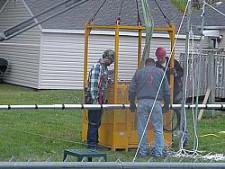 Fastening the 80M antenna to cage to raise it up.
